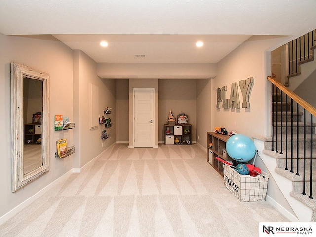 game room featuring baseboards, recessed lighting, and light carpet