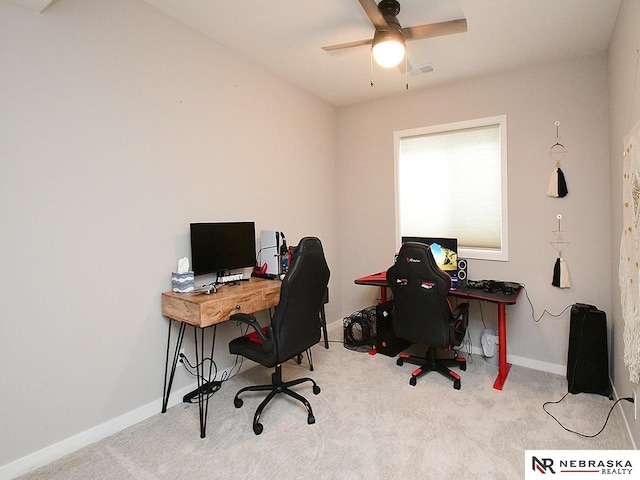 carpeted office featuring baseboards and ceiling fan