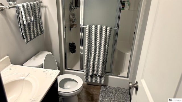 full bath featuring toilet, wood finished floors, and vanity