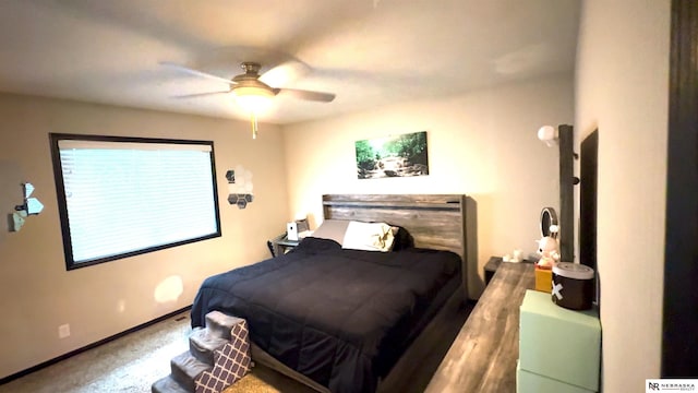 bedroom with baseboards, carpet flooring, and a ceiling fan