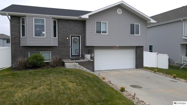 split foyer home featuring fence and brick siding