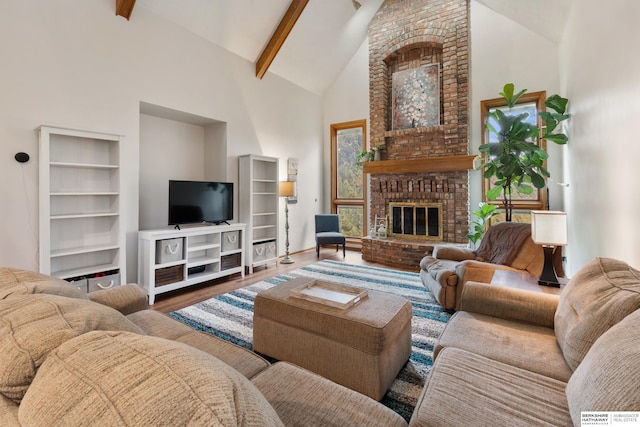 living area with high vaulted ceiling, baseboards, beam ceiling, and wood finished floors