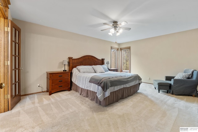 bedroom with a ceiling fan, baseboards, and light colored carpet