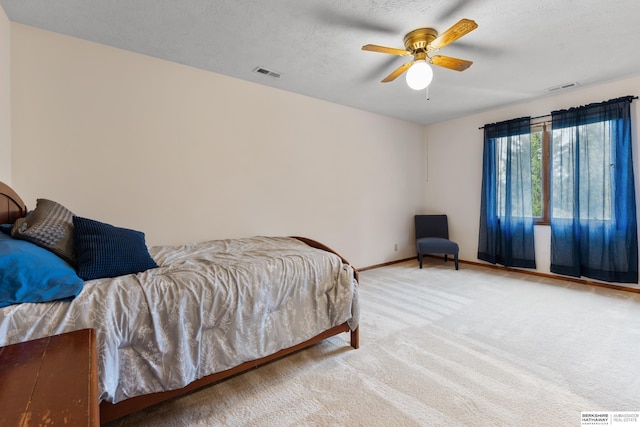 bedroom featuring visible vents, baseboards, carpet floors, and ceiling fan