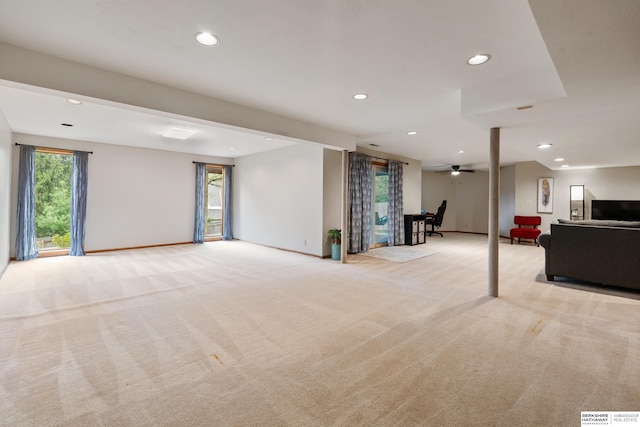 unfurnished living room featuring recessed lighting, a ceiling fan, light colored carpet, and baseboards