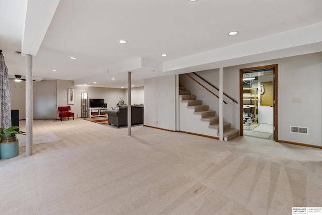 finished below grade area featuring visible vents, stairs, baseboards, recessed lighting, and carpet