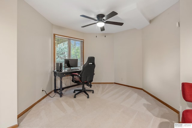 carpeted office space with baseboards and a ceiling fan