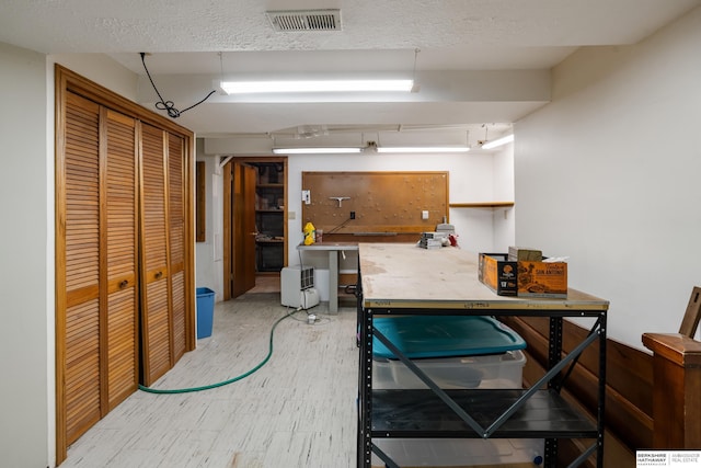 below grade area featuring visible vents and wood finished floors