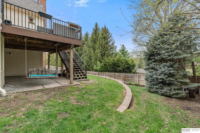 view of yard featuring stairway, a patio, a wooden deck, and a fenced backyard