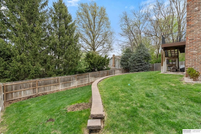 view of yard with a fenced backyard and stairway