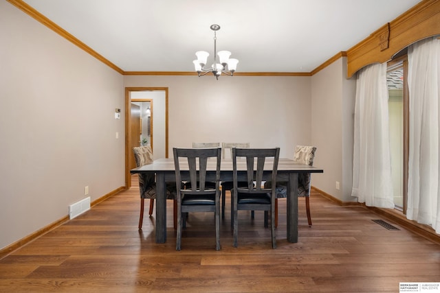 dining room with visible vents, ornamental molding, baseboards, and a chandelier