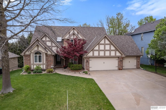 tudor-style house with brick siding, driveway, a front yard, and a garage