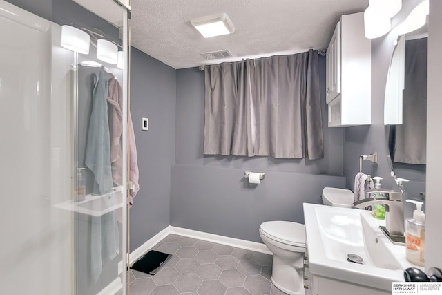full bath with tile patterned flooring, toilet, a textured ceiling, baseboards, and visible vents