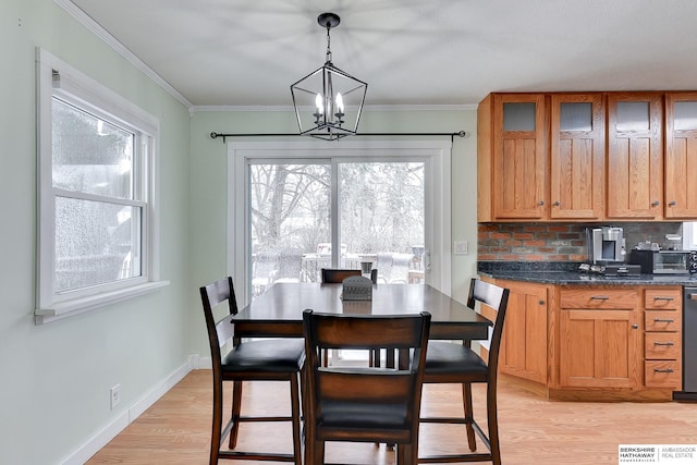 dining area with baseboards, a chandelier, a healthy amount of sunlight, and light wood-type flooring