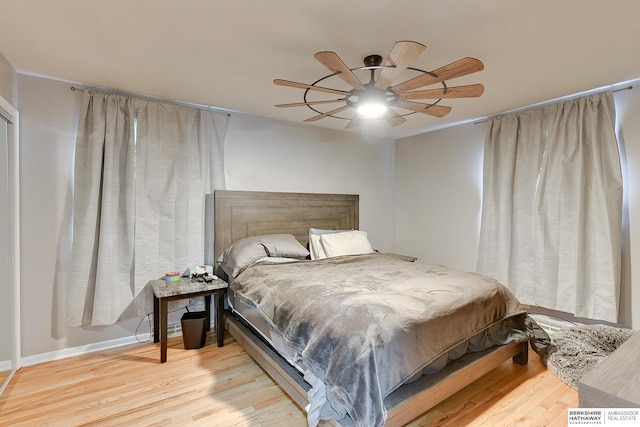 bedroom featuring baseboards, ceiling fan, and wood finished floors