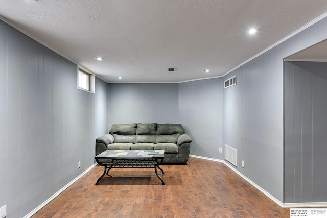 sitting room with recessed lighting, visible vents, ornamental molding, and hardwood / wood-style floors