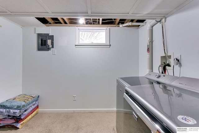 laundry room featuring laundry area, washer and clothes dryer, baseboards, and electric panel