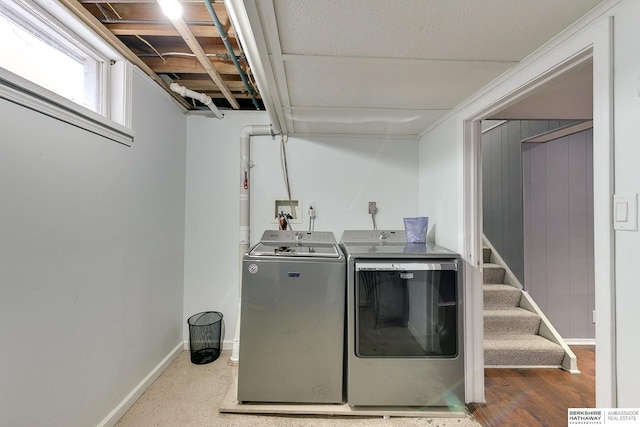 washroom featuring laundry area, washer and clothes dryer, and baseboards
