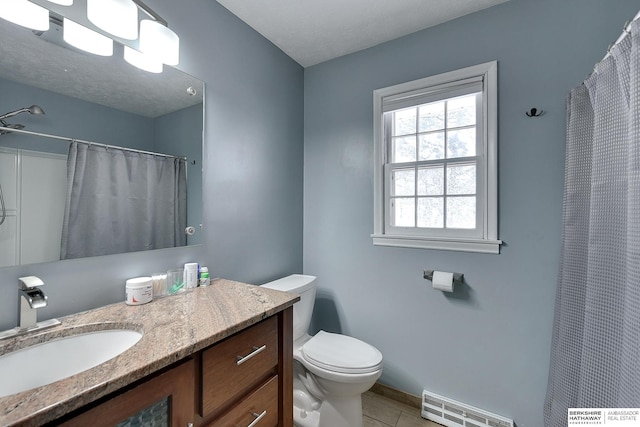 full bathroom featuring visible vents, vanity, toilet, baseboards, and tile patterned floors
