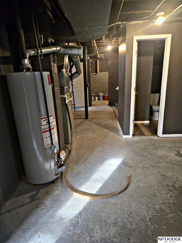 unfinished basement featuring gas water heater