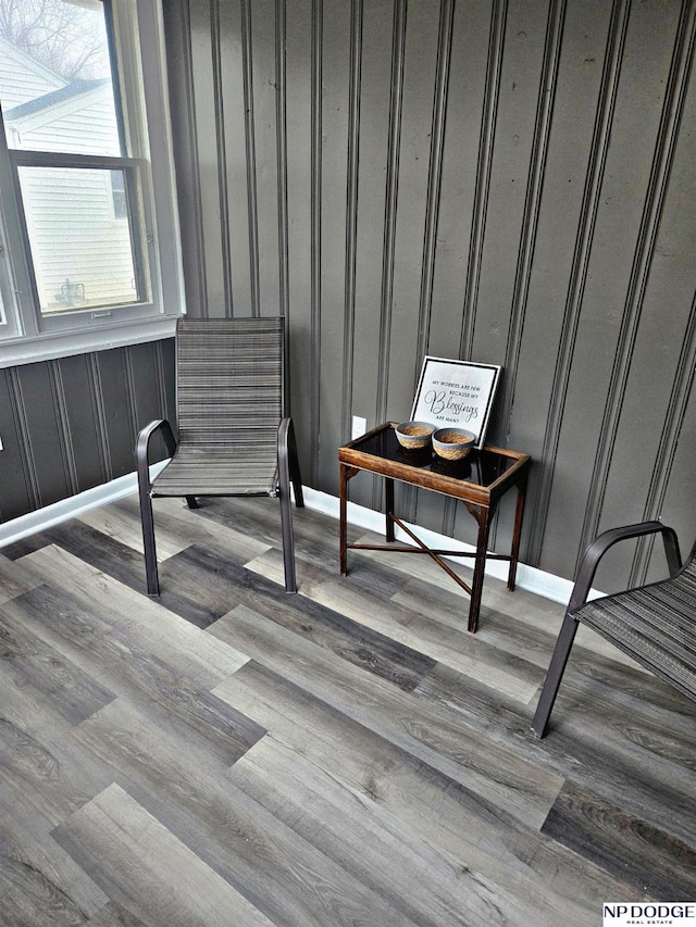 interior space featuring baseboards and wood finished floors