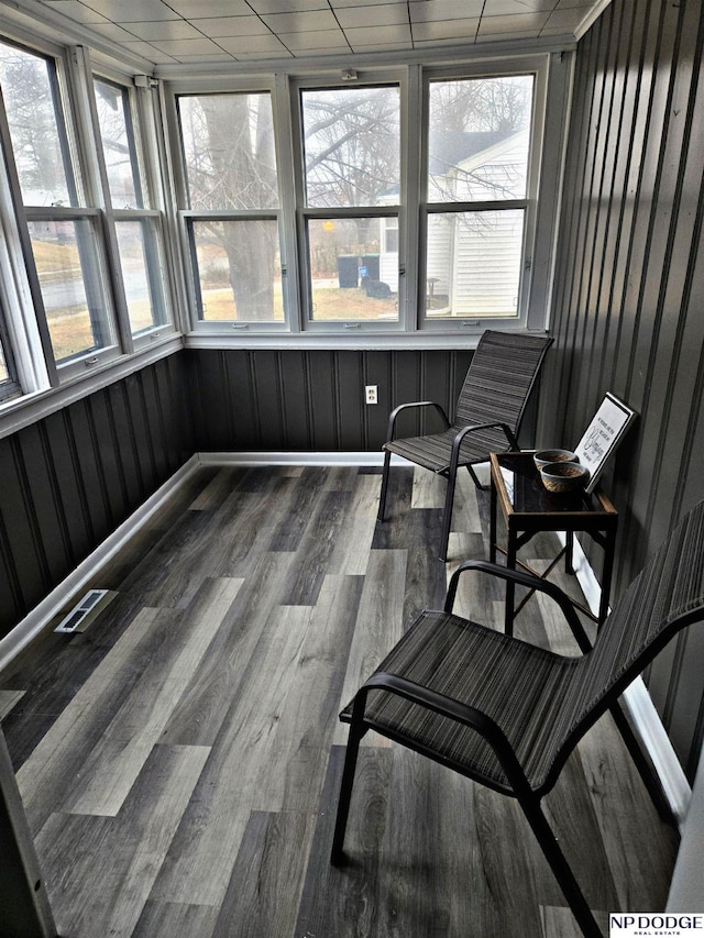 sunroom / solarium with wood finished floors and visible vents