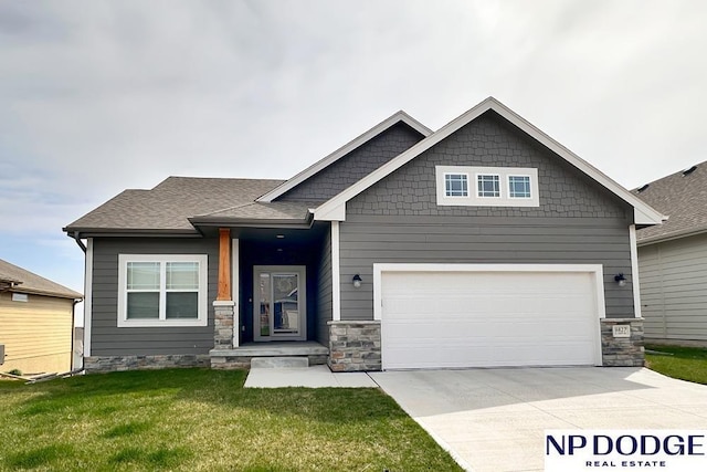 craftsman-style house with an attached garage, driveway, stone siding, and a front lawn