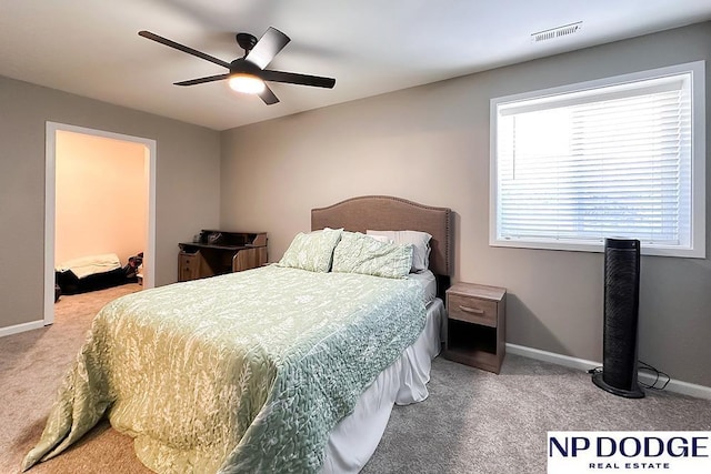 carpeted bedroom with ceiling fan, baseboards, and visible vents