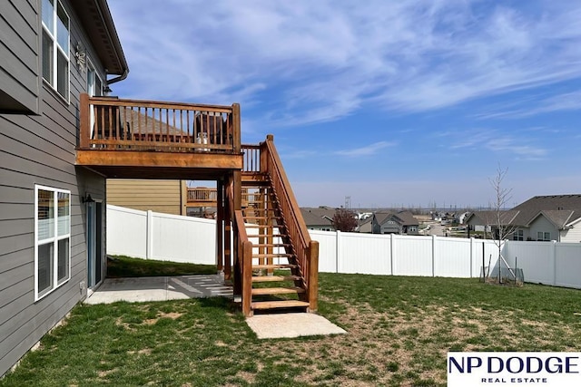 view of yard with stairway, a fenced backyard, a residential view, a patio area, and a deck