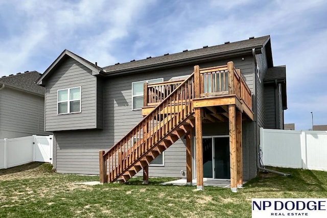 back of property featuring a wooden deck, a yard, a fenced backyard, and stairs