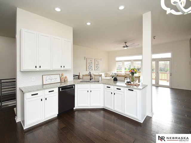 kitchen featuring dark wood finished floors, dishwasher, a sink, a peninsula, and ceiling fan