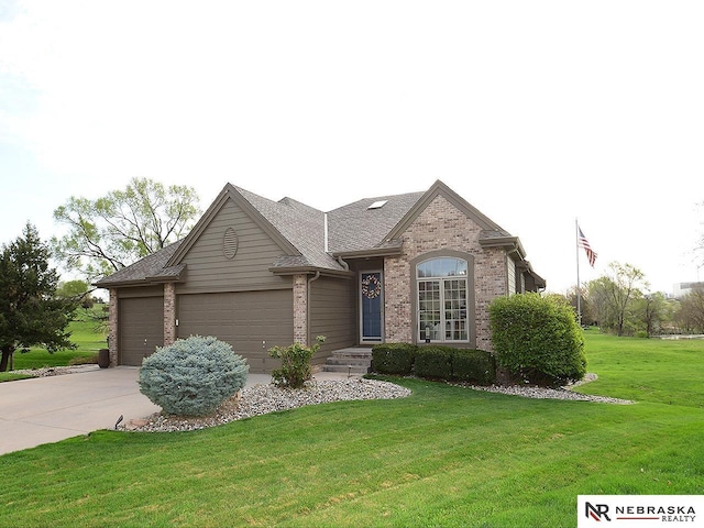 view of front of property with a front lawn, driveway, brick siding, and a garage
