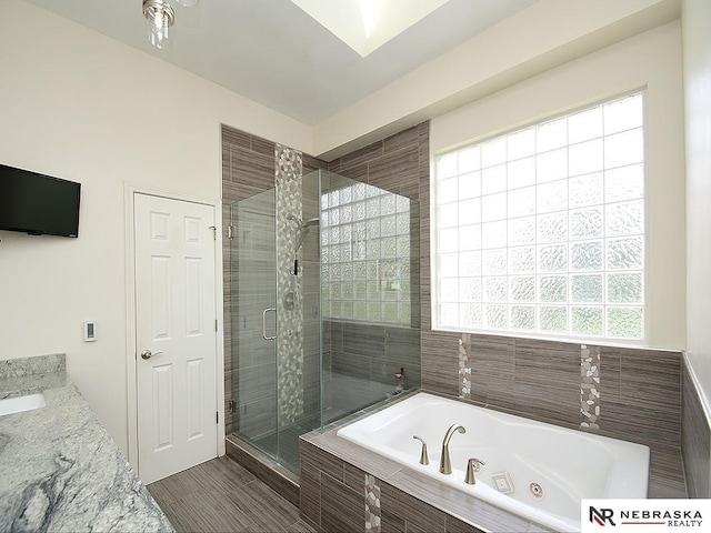 full bath with a shower stall and a tub with jets