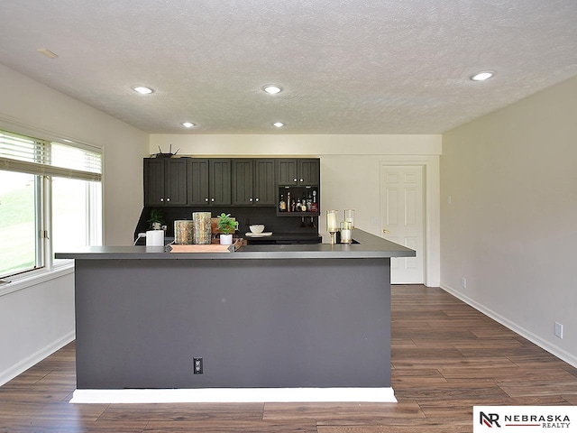 kitchen featuring baseboards, recessed lighting, a textured ceiling, and dark wood-style flooring
