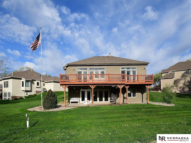 back of house featuring a lawn, a wooden deck, a patio area, and french doors