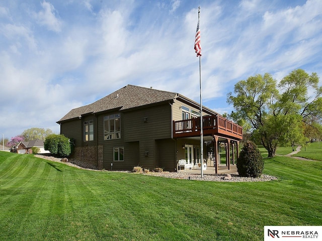 back of house with a wooden deck, a yard, and a patio