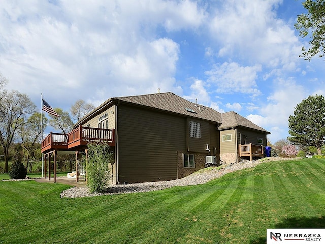 back of property with central air condition unit, a lawn, and a deck