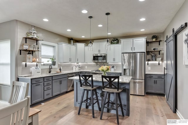 kitchen featuring a sink, appliances with stainless steel finishes, open shelves, and recessed lighting