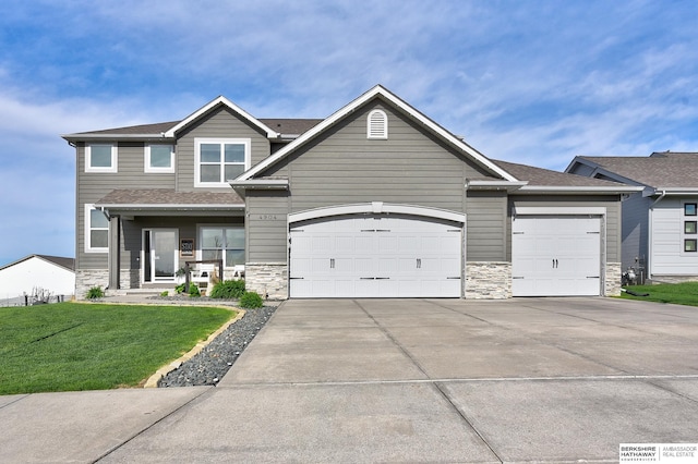 craftsman house featuring a garage, stone siding, and concrete driveway