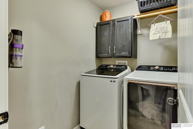 washroom with washing machine and dryer and cabinet space