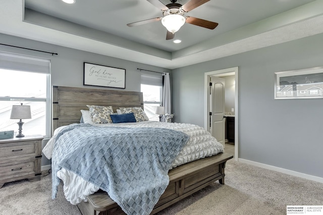 bedroom featuring recessed lighting, baseboards, light colored carpet, and a raised ceiling