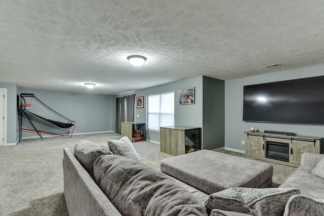 carpeted living room featuring a textured ceiling, baseboards, visible vents, and a fireplace