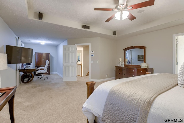carpeted bedroom featuring a textured ceiling, baseboards, and ceiling fan