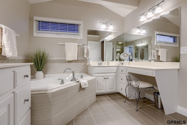 bathroom featuring vanity, tile patterned flooring, a garden tub, and lofted ceiling