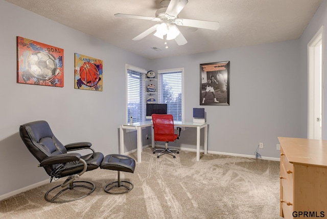 home office with ceiling fan, a textured ceiling, visible vents, baseboards, and carpet