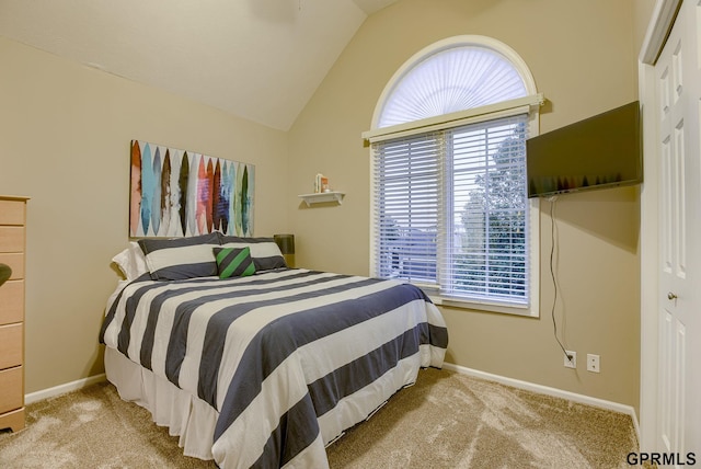 carpeted bedroom with baseboards, vaulted ceiling, and multiple windows