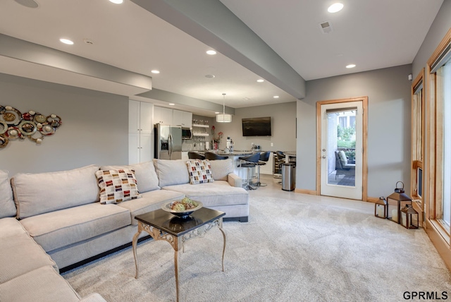 living area featuring baseboards, light carpet, recessed lighting, and visible vents