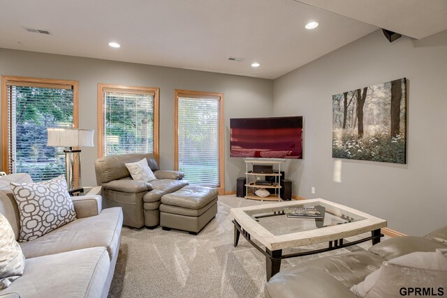 living area featuring recessed lighting, visible vents, light carpet, and a wealth of natural light