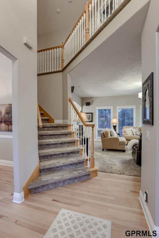 stairs featuring baseboards and wood finished floors