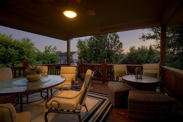 deck at dusk featuring outdoor dining area